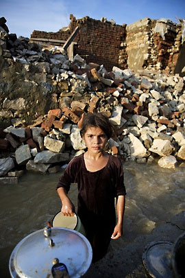 Photo: Eight-year-old Amreen washes dishes in rainwater