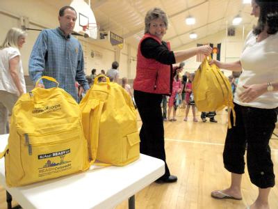 Photo: Emergency Manager LaRiea Thompson hands out back packs stocked with emergency preparedness supplies
